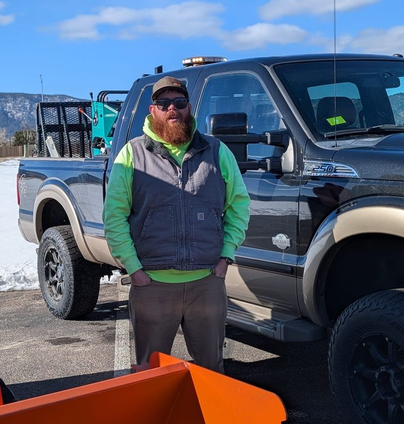 Al Mason standing beside his plow truck