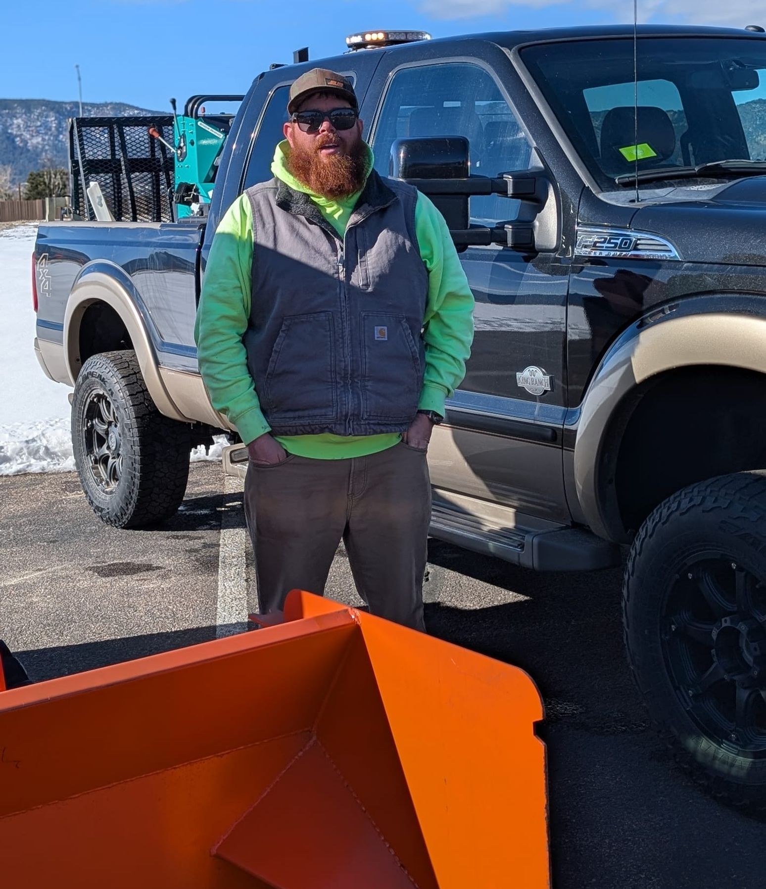 Al Mason, owner of Red Beard's, standing beside his plow truck