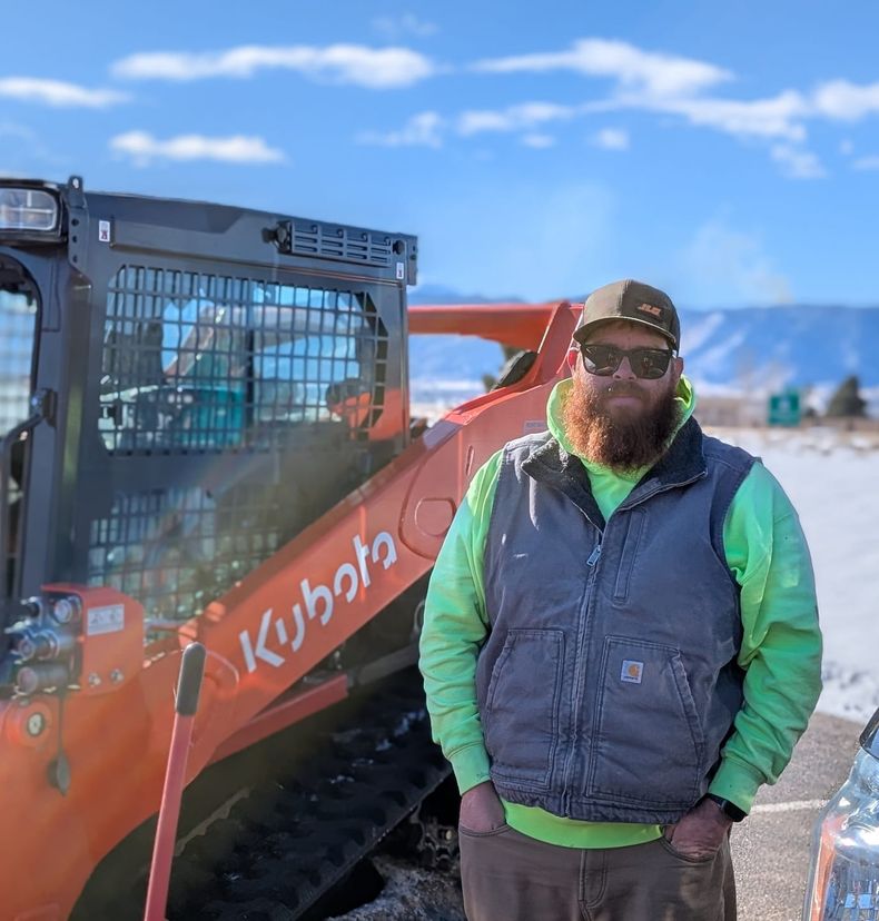 Al Mason standing beside the Kubota track loader
