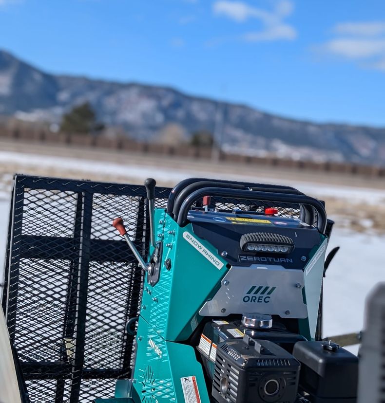 Tracked Snow Rhino sidewalk plow with work lights