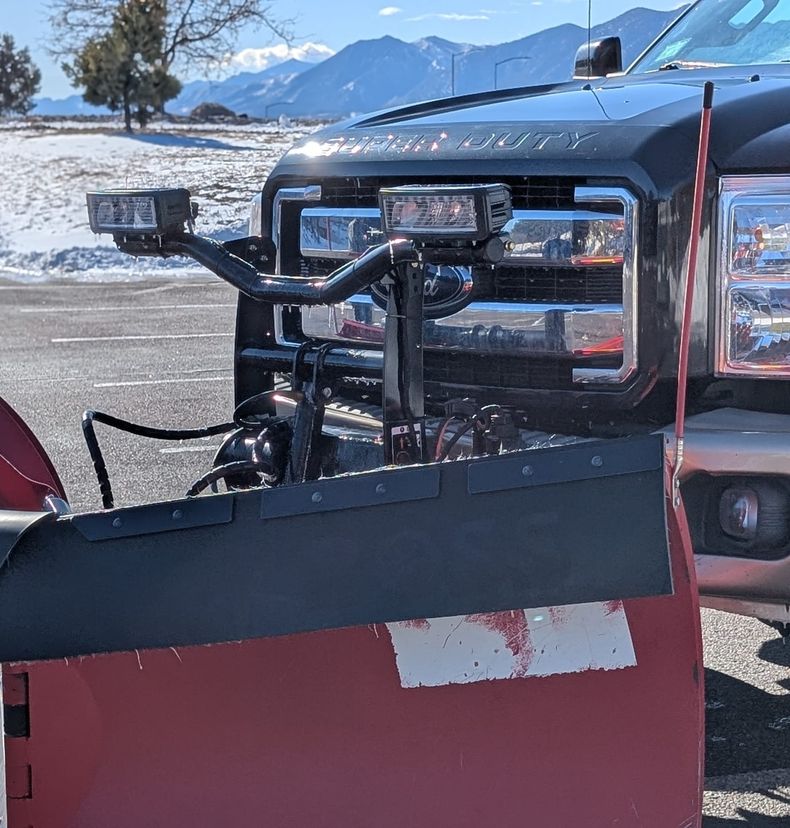 Close-up of a BOSS V-plow mounted on a pickup