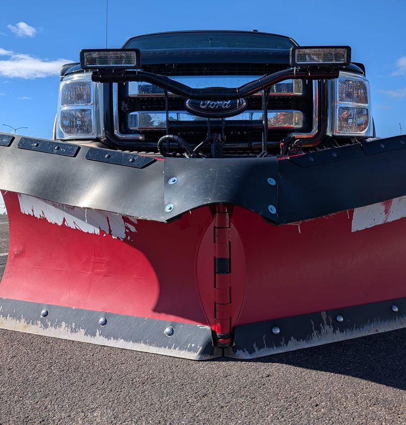 Red BOSS V-plow blade angled for clearing