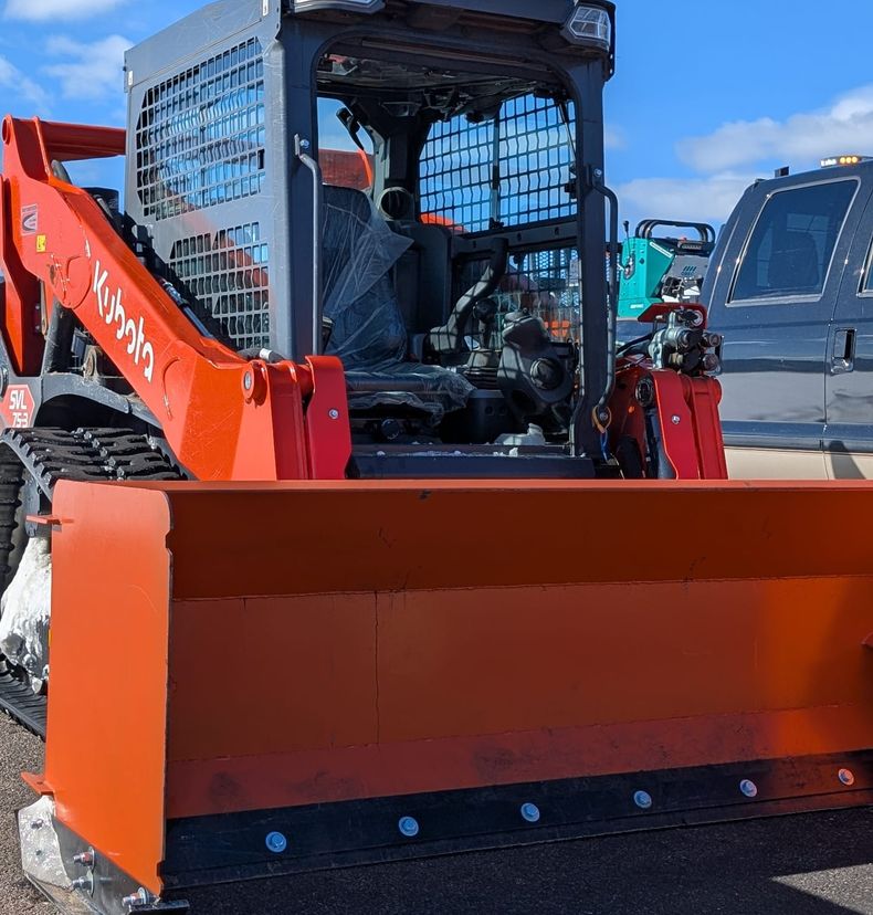 Kubota track loader with a wide snow pusher