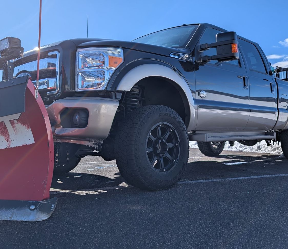 Red Beard's pickup fitted with a red BOSS V-plow